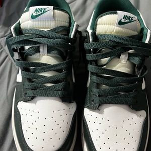 Green and white Nike shoes
